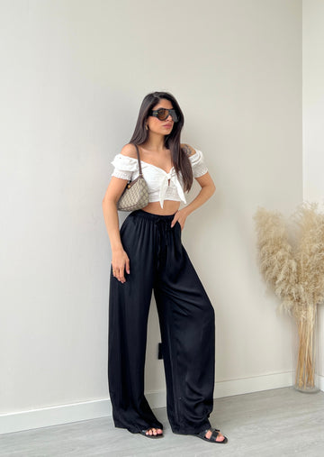 Pantalone effetto raso a palazzo nero