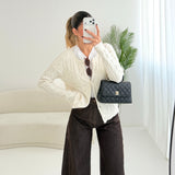Cardigan con trecce e bottoni foderati panna