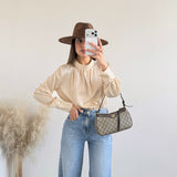 Blusa collo alto a pois gialla